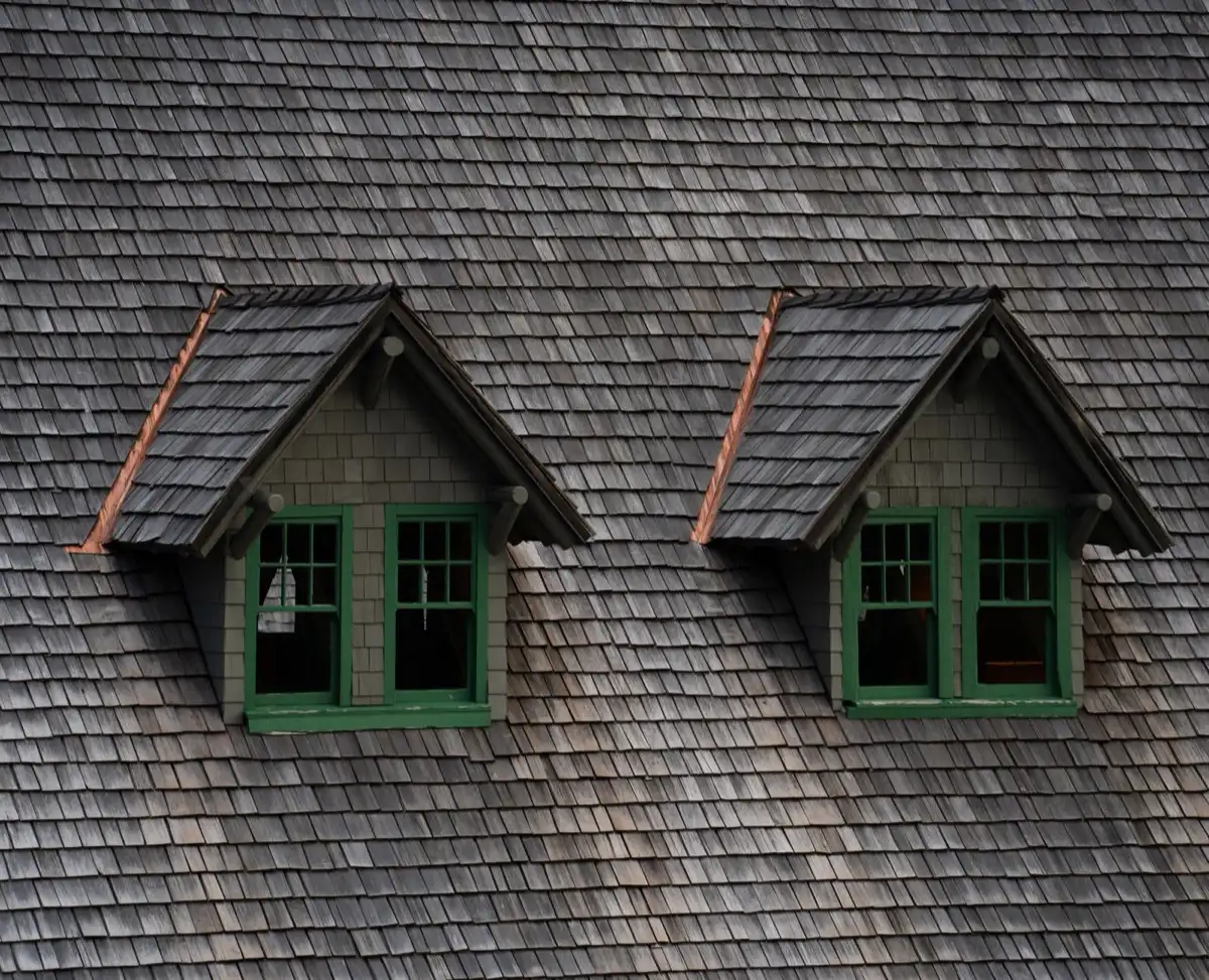 Dormers on a shingle roof in Del Rio, TX, where step flashing and kickout flashing carry water past the walls
